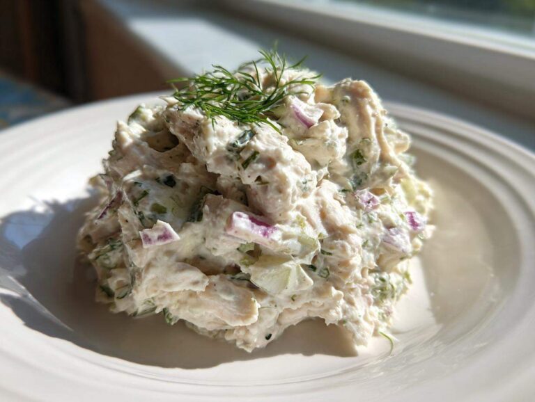 Amazing 10-Minute Cottage Cheese Chicken Salad A scoop of creamy cottage cheese chicken salad mixed with red onion and celery, garnished with fresh dill.