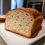 Close-up of the soft, airy crumb of a freshly baked whole wheat bread loaf.