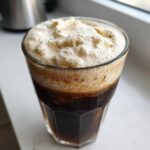 A glass of cold brew coffee topped generously with thick, airy Copycat Starbucks Vanilla Sweet Cream Cold Foam.
