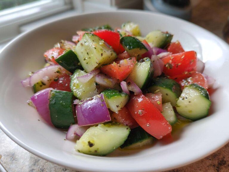 Close-up of a vibrant Cucumber Onion Tomato Salad with chunks of cucumber, red tomato, and purple onion dressed lightly.