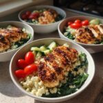 Four bowls featuring Greek Yogurt Marinated Chicken Bowls with quinoa, spinach, tomatoes, and cucumbers.