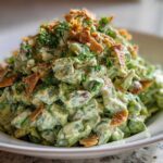 A generous serving of Green Goddess Crunch Salad coated in creamy dressing, topped with crispy bits and fresh dill.