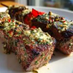 Close-up of grilled beef cubes on skewers, generously topped with melted Cowboy Butter.