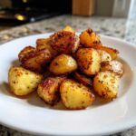 A mound of perfectly roasted, golden potatoes seasoned with herbs, served as an amazing side dish for less than 10 bucks.