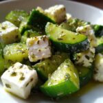 Close-up of a vibrant Cucumber Feta Salad with chunks of cucumber and feta cheese tossed in a light dressing.