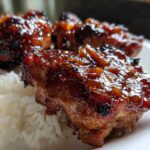 Close-up of sticky, glazed Teriyaki Pineapple Chicken Thighs served over white rice.