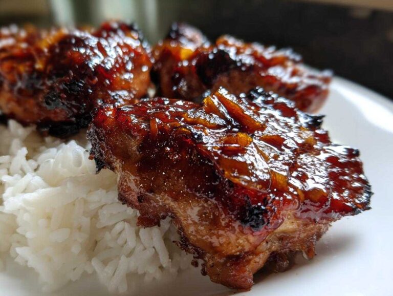 Close-up of sticky, glazed Teriyaki Pineapple Chicken Thighs served over white rice.