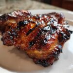 Close-up of perfectly caramelized and charred Huli Huli Chicken with a sticky glaze.