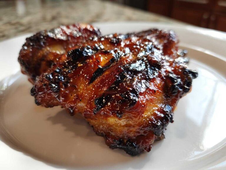 Close-up of perfectly caramelized and charred Huli Huli Chicken with a sticky glaze.