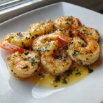 Close-up of juicy, cooked Lemon Garlic Shrimp coated in a rich, buttery sauce with minced garlic and parsley.