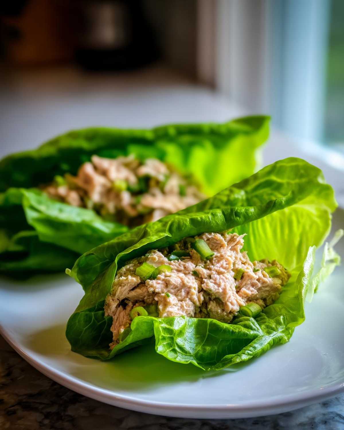Two tuna salad lettuce wraps, showing creamy tuna mixed with green onions inside crisp lettuce cups—a perfect example of the Easy Easiest Way Eat Healthy.