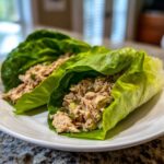 Two tuna salad lettuce wraps on a white plate, showcasing the Easy Easiest Way Eat Healthy method.