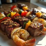 Close-up of perfectly cooked Grilled Steak and Shrimp Skewers drizzled with garlic butter.