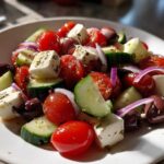 Close-up of fresh ingredients like tomatoes, cucumbers, feta, and olives, perfect for a quick Pasta Salad.